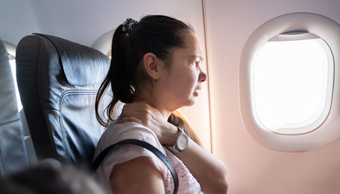 Woman,With,Neck,Pain,After,Long,Flight